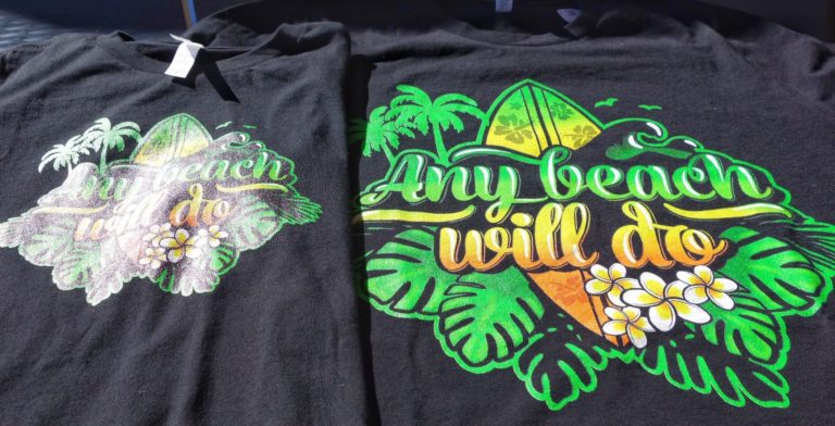 Two black t-shirts with a beach print on