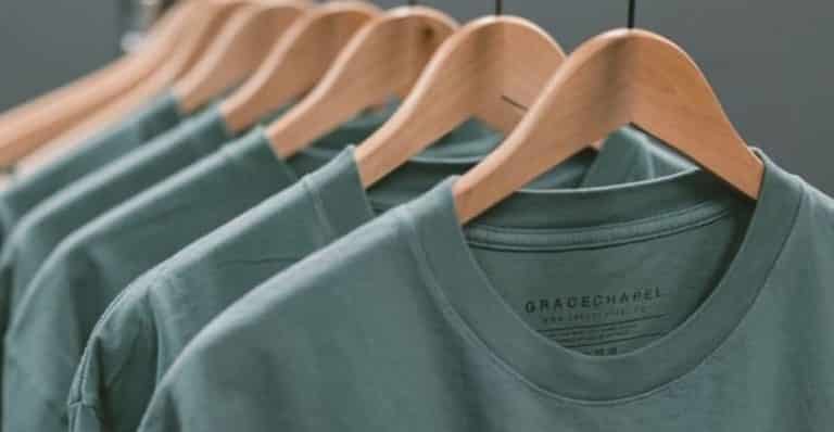 Green t-shirts on a hanger.